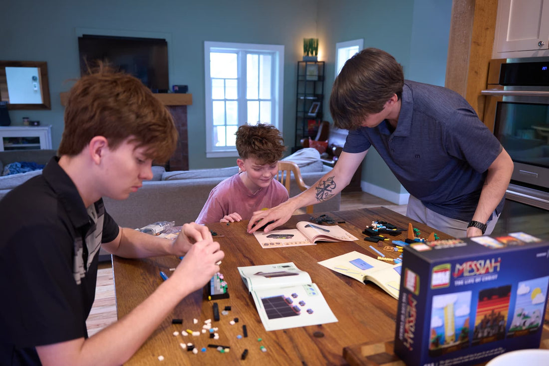 Family building the Life of Christ set together at the table